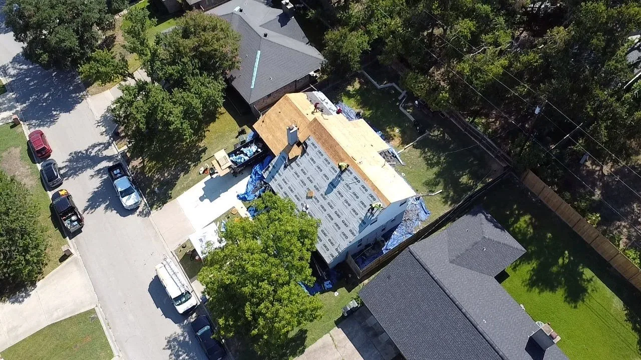 Aerial view of a roof replacement in its early tear-off stage