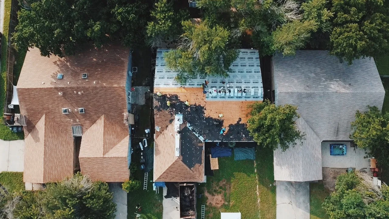 Aerial top-down view of a roof torn off to the bare decking during replacement