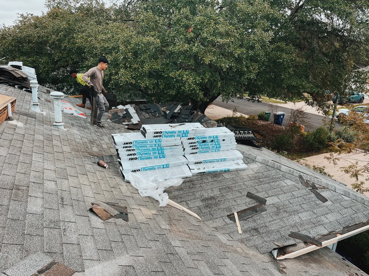 IKO Dynasty shingle bundles staged on roof during replacement job by Urtiz Roofing